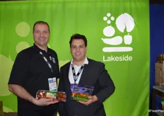 Mario Testani and Justin Henkel with Lakeside Produce show cherries on-the-vine as well as organic mini cukes in re-branded packaging. The backdrop shows the company's new logo.